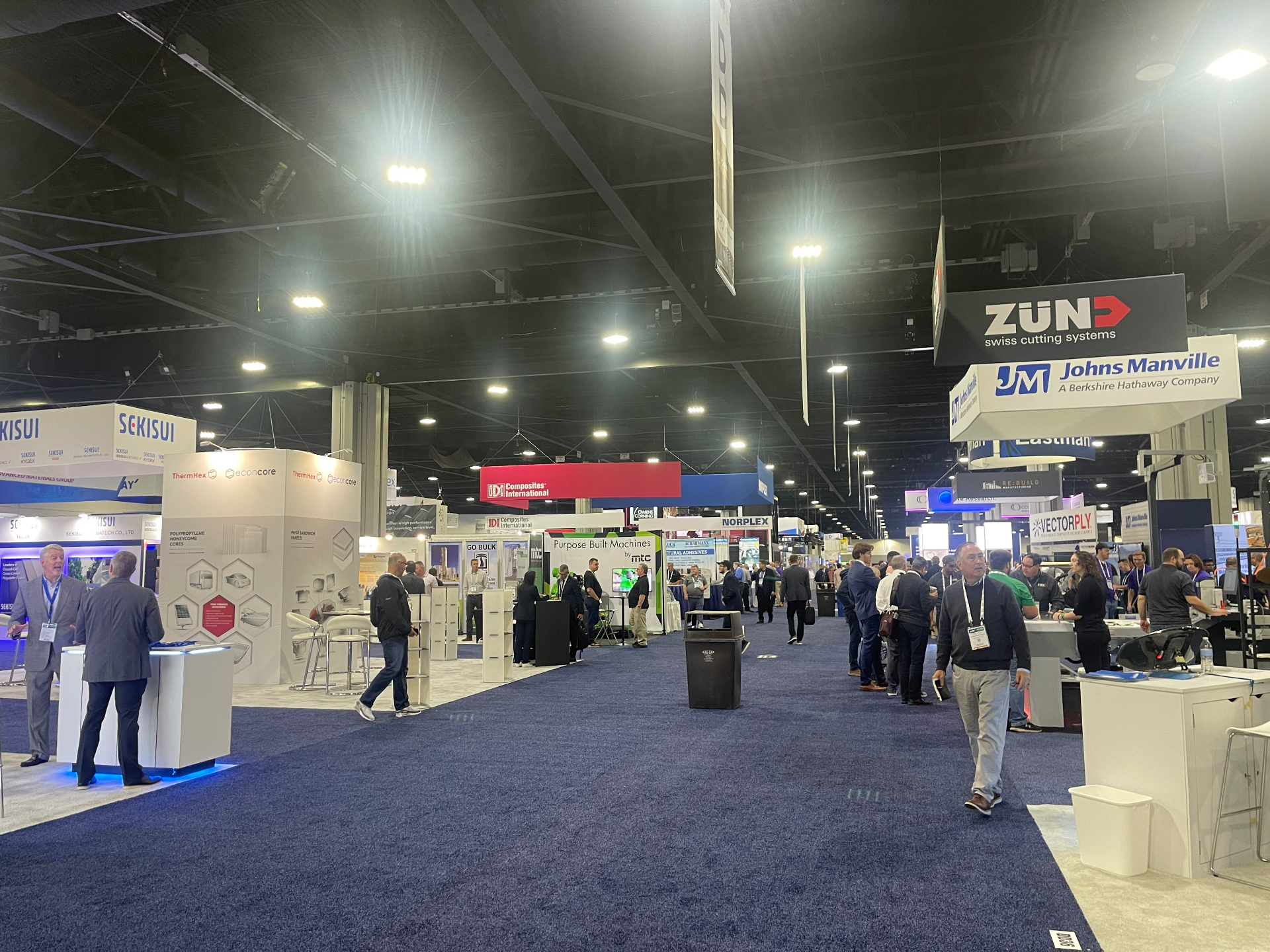 Wide aisle view of the CAMX 2023 show floor with Sekisui, Zund, and Johns Manville booths