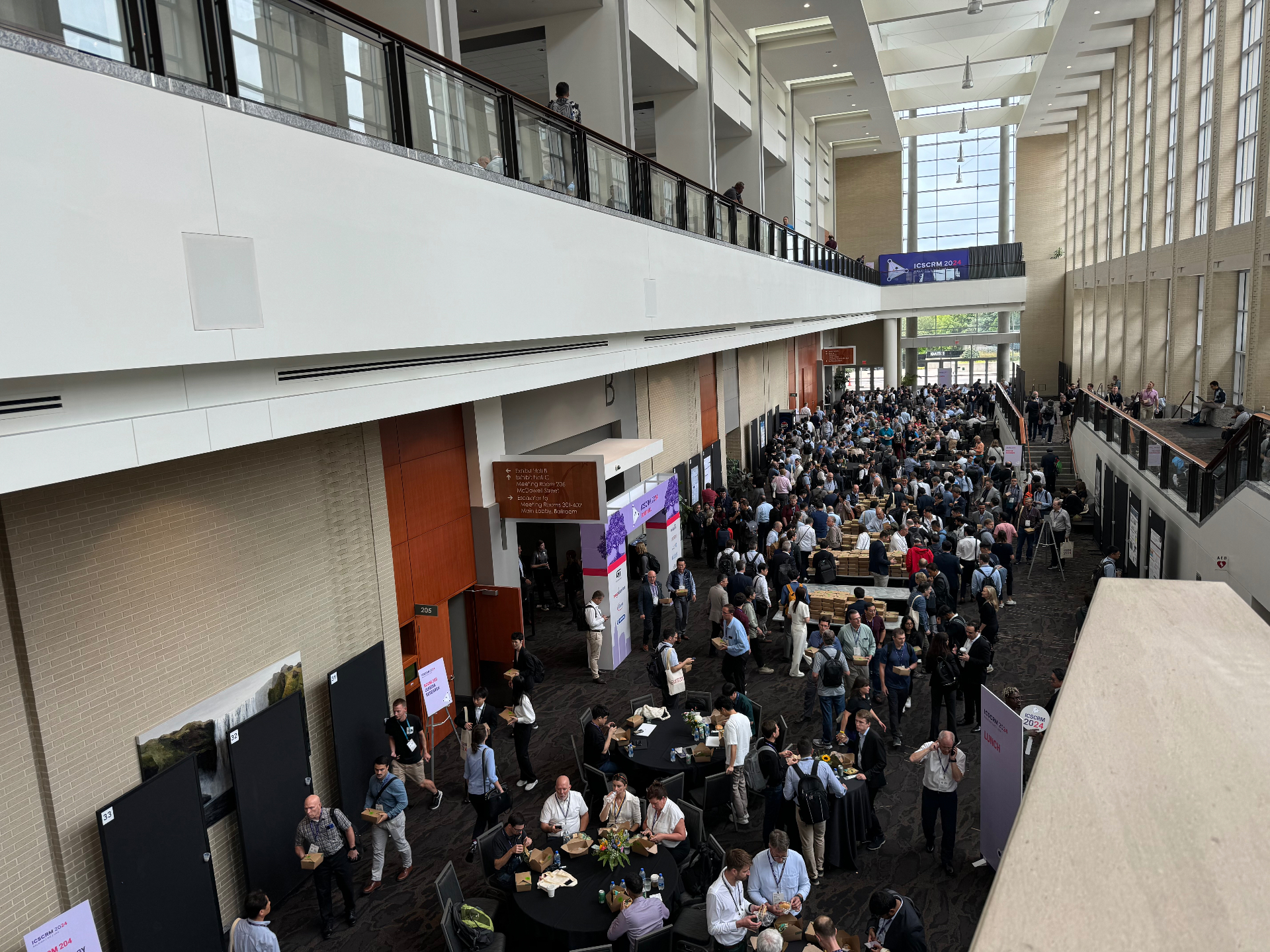 Large ICSCRM 2024 conference lobby in Raleigh filled with attendees during a session break
