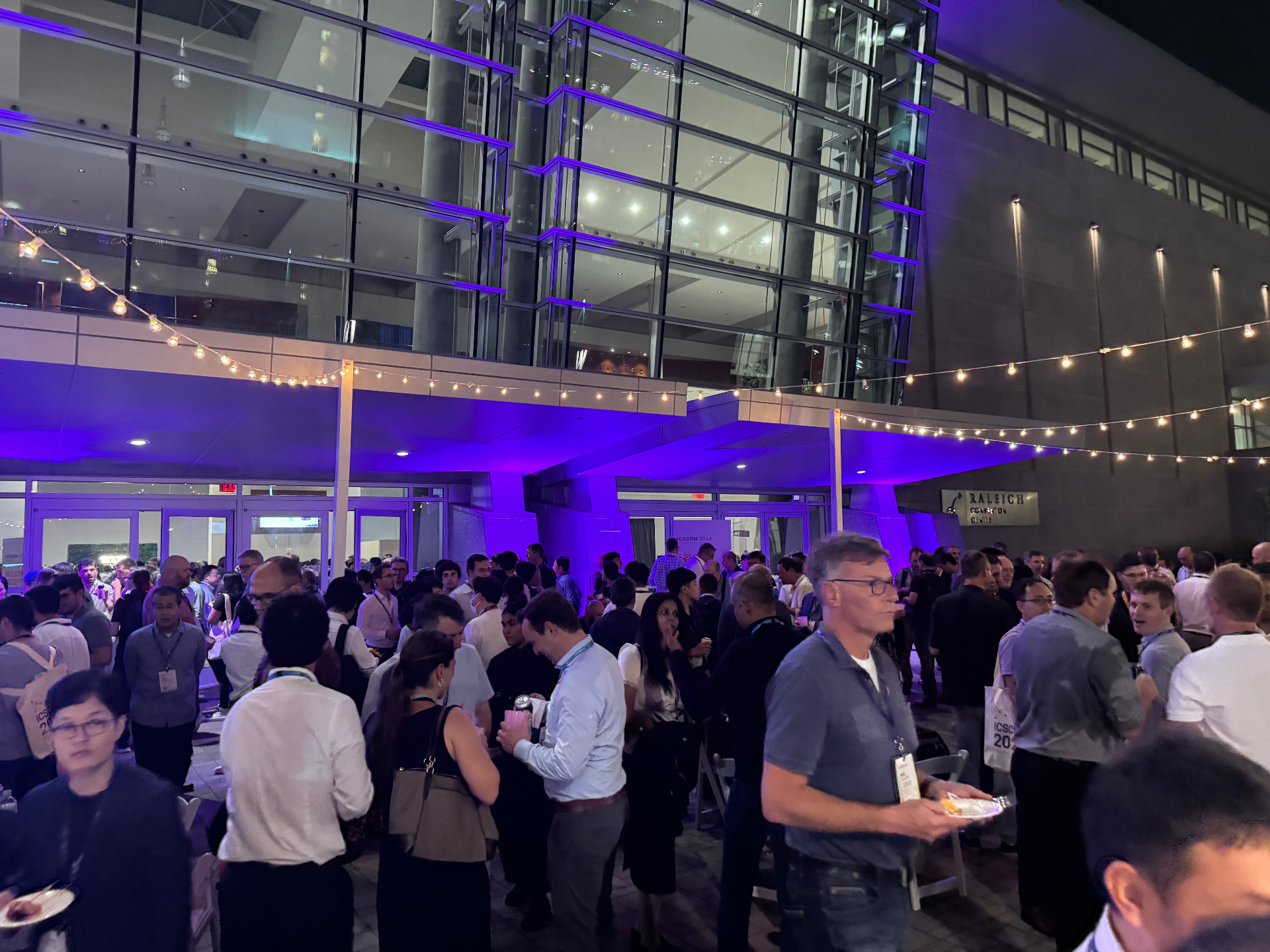 Evening networking reception crowd outside the Raleigh Convention Center during ICSCRM 2024