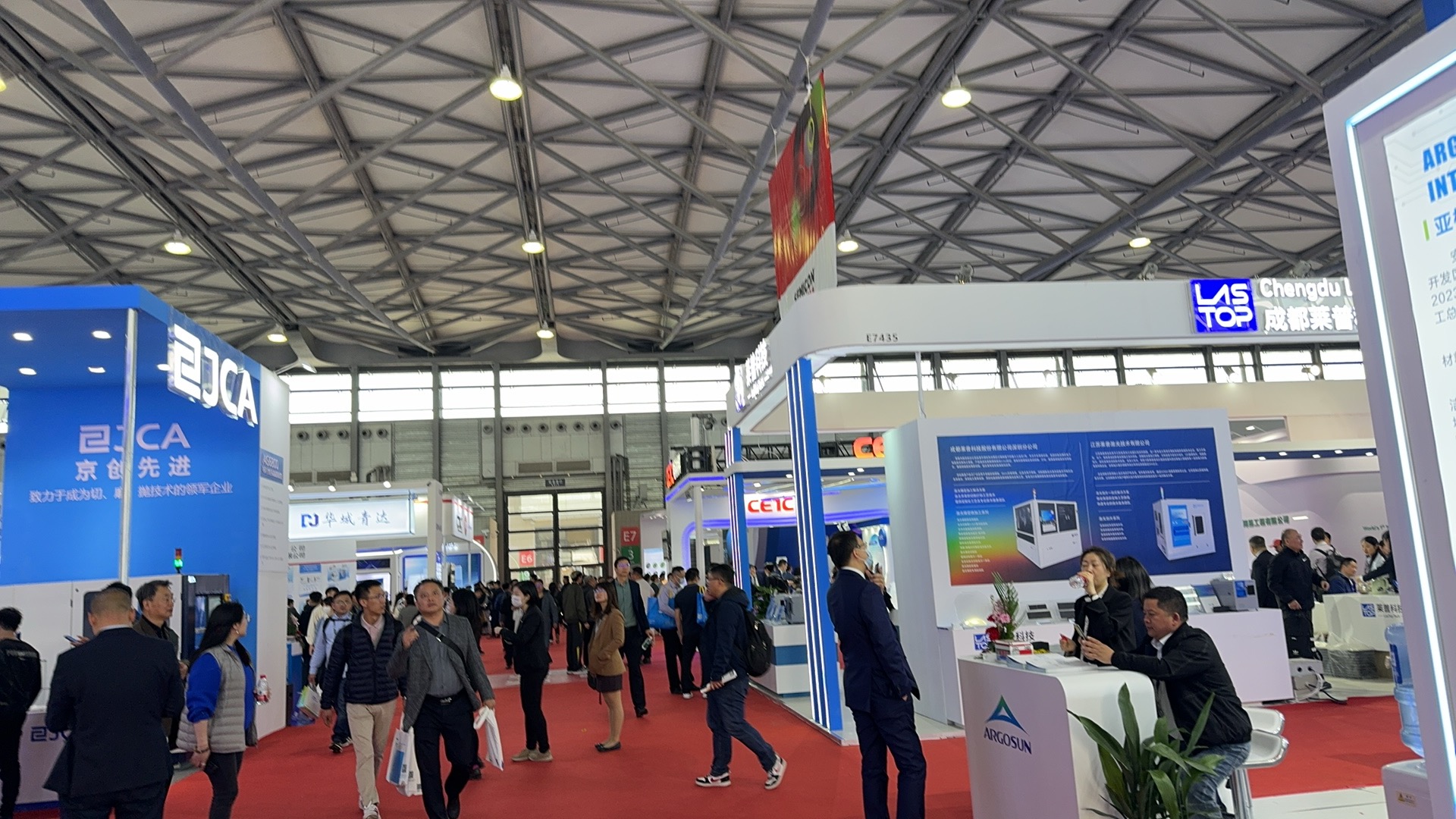 Wide aisle view at SEMICON China 2024 with JCA, CETC, Lastop, and Argosun booths in Shanghai