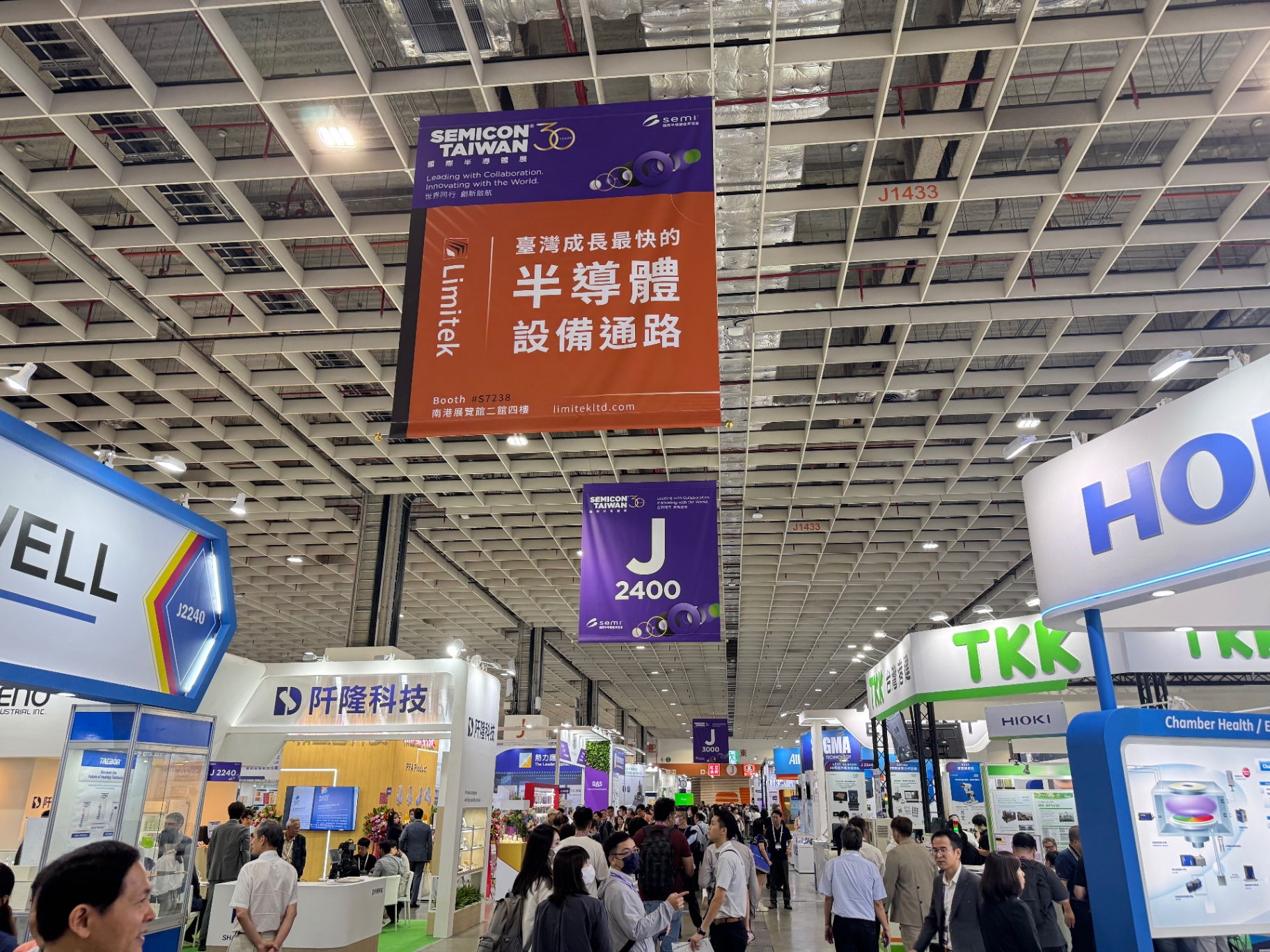 Crowded SEMICON Taiwan exhibition hall with semiconductor equipment and materials booths