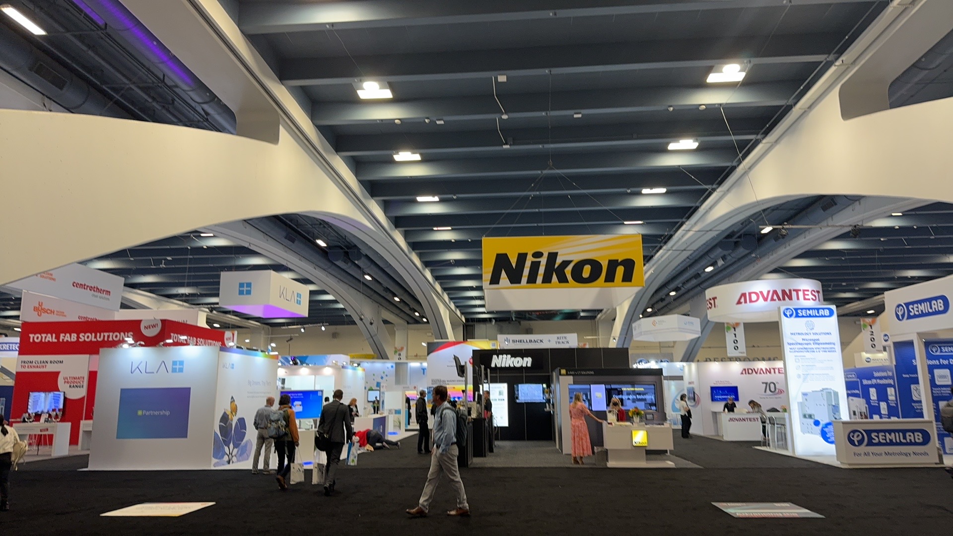 SEMICON West 2024 show floor with Nikon, KLA, Advantest, and Semilab booths