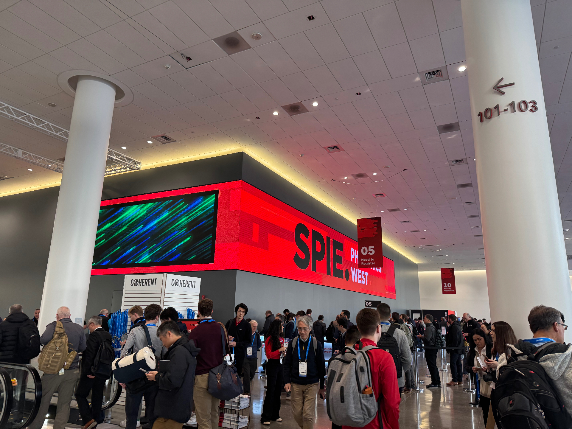 Crowded registration area and LED wall at SPIE Photonics West